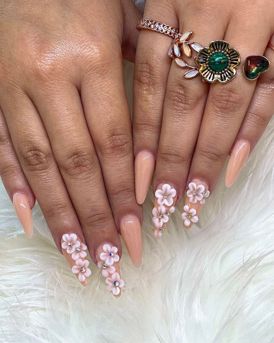 Nude-peach nails with 3D florals and gold jewelry